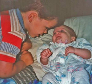 Austin "focusing" on his baby sister. (1995)